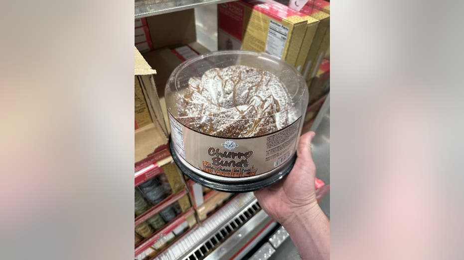 Bakery Street's Churro Bundt Cake held up in a Costco store.