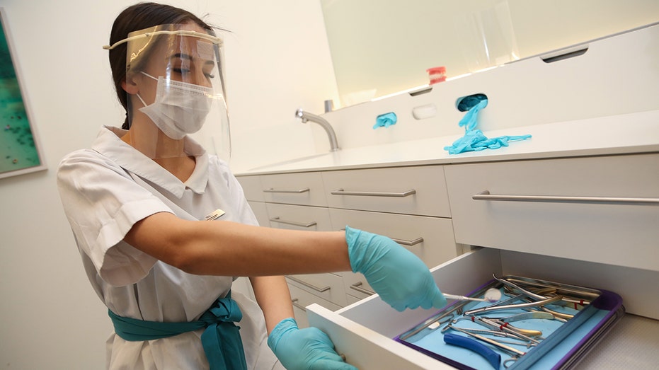 Orthodontist reaching for tools