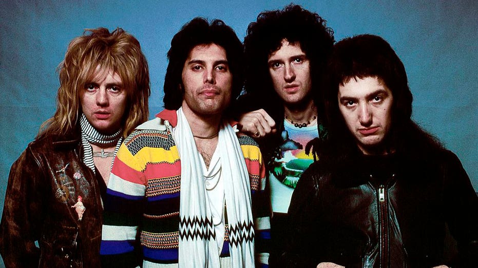 the band members of queen posing together