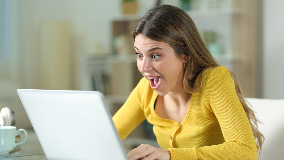 amazed woman on computer