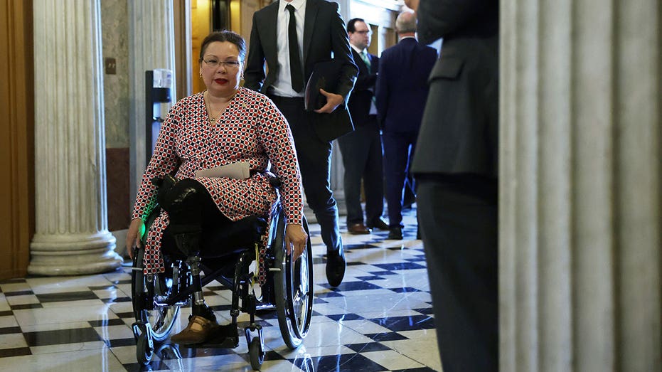 Sen. Tammy Duckworth in her wheelchair coming down Capitol hallway