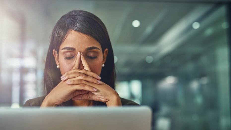 professional woman stressed at computer