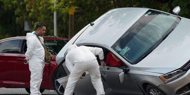 Forensic medical examiners at crime scene