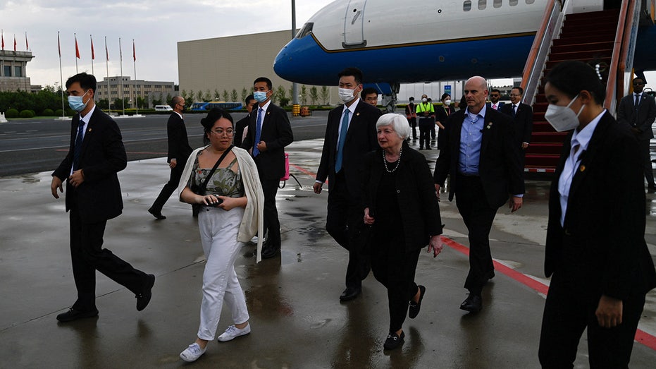 Yellen arrives at Beijing airport surrounded by officials
