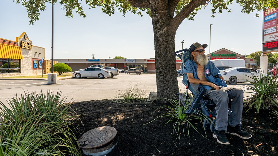 Homeless man outside Austin businesses