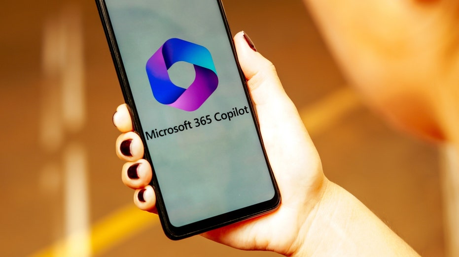 The Microsoft 365 Copilot logo is displayed on a smartphone screen