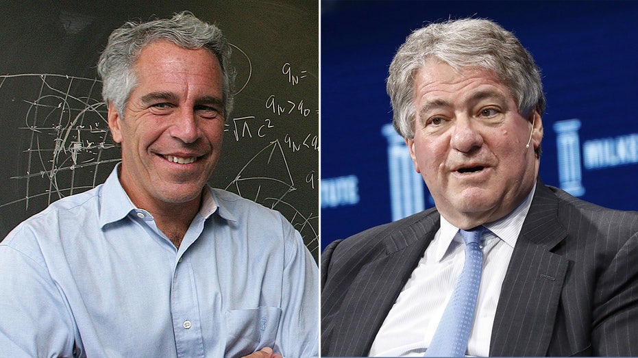 Jeffrey Epstein standing in front of a blackboard next to Leon Black in a suit.