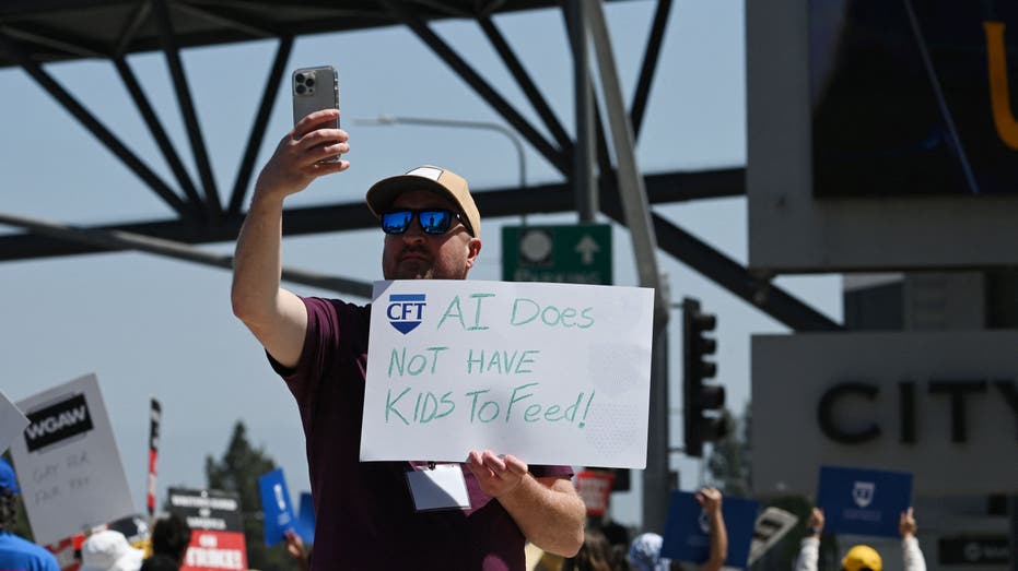 A man holds up an anti-artificial intelligence sign during the Hollywood strike