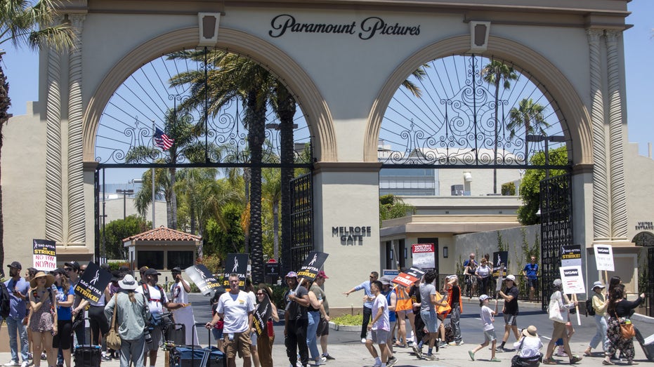 Actors and writers marching in front of Paramount studios