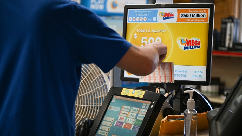 A cashier inserts lottery tickets at a gas station