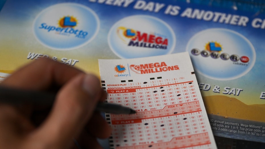 A person plays the Mega millions lottery