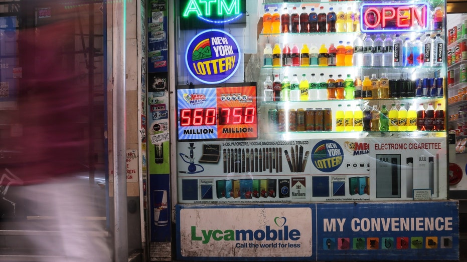 A Powerball and Mega Millions lottery advertisement on a storefront