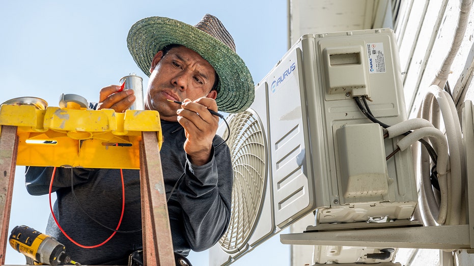 Air conditioning tech works on unit in Austin, Texas