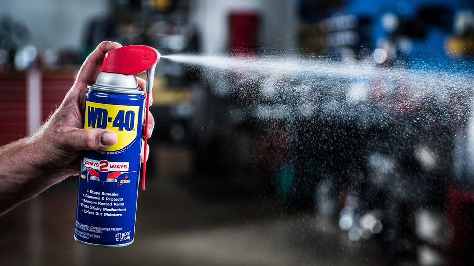 Hand spraying WD-40 Smart Straw product