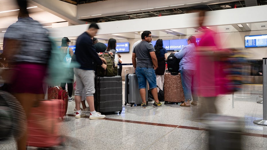 travelers standing at american airlines ticket counter