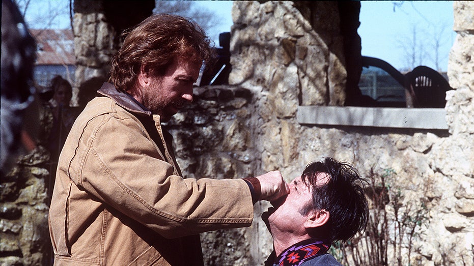 Chuck Norris as Walker twisting a man's nose