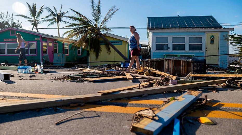Florida residents walk through hurrican damage
