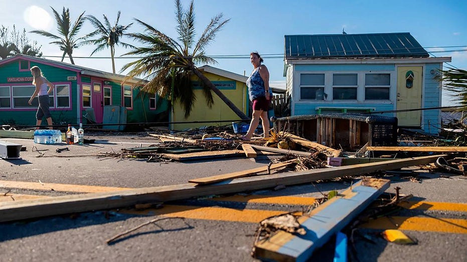 Florida residents walk through hurrican damage