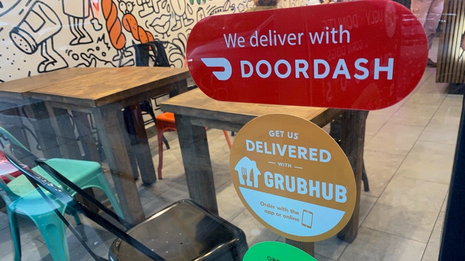 food delivery signs in restaurant window