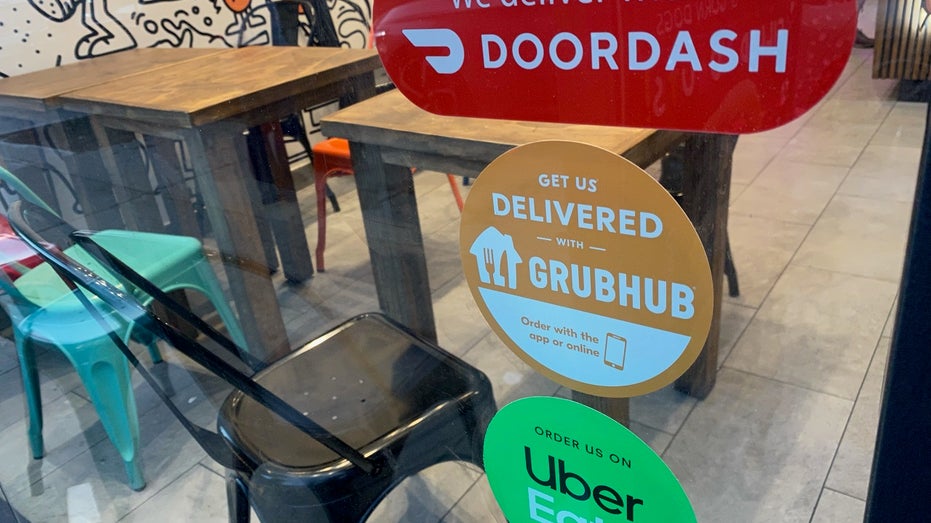 food delivery signs in restaurant window