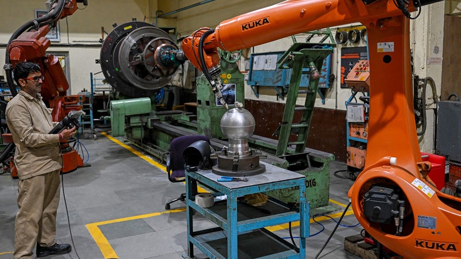 Indian engineer works at aerospace manufacturing plant