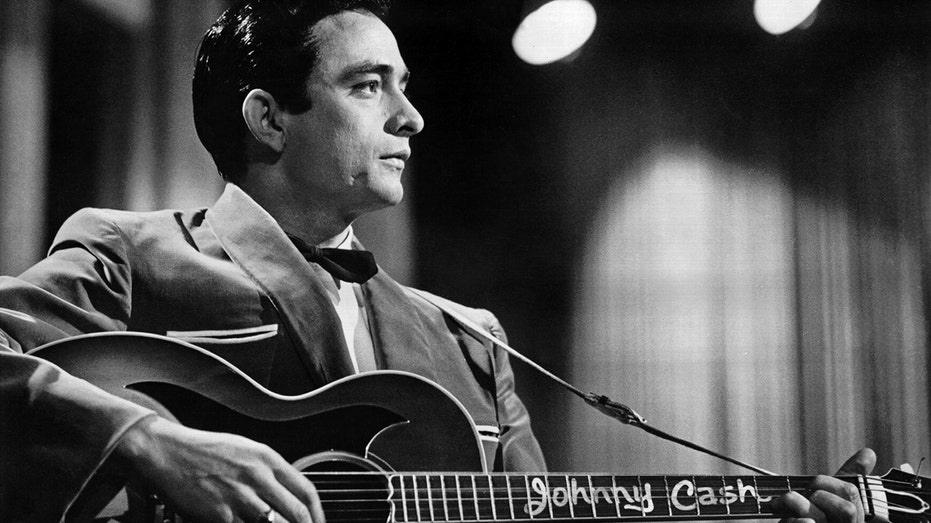 Country singer/songwriter Johnny Cash performs onstage in 1957