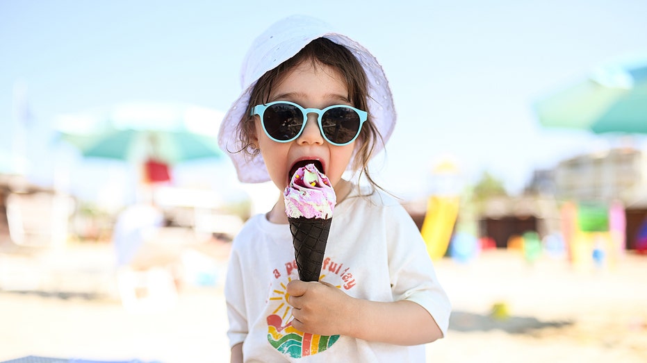 little girl licking ice cream cone