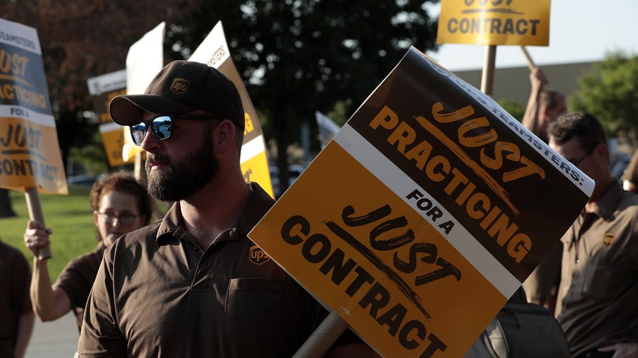 UPS worker holds sign during protest