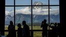 Visitors take photos of the Grand Teton National Park mountain range from Jackson Lake Lodge ahead of the the Jackson Hole economic symposium in Moran, Wyoming, US, on Thursday, Aug. 25, 2022. The Federal Reserve Bank of Kansas Citys annual gathering in Jackson Hole, Wyoming, returned to an in-person conference for the first time since the pandemic spread in 2020. Photographer: David Paul Morris/Bloomberg via Getty Images - Fox Business News