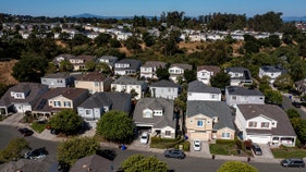 The cost of buying a house hit another record high as mortgage rates spike
