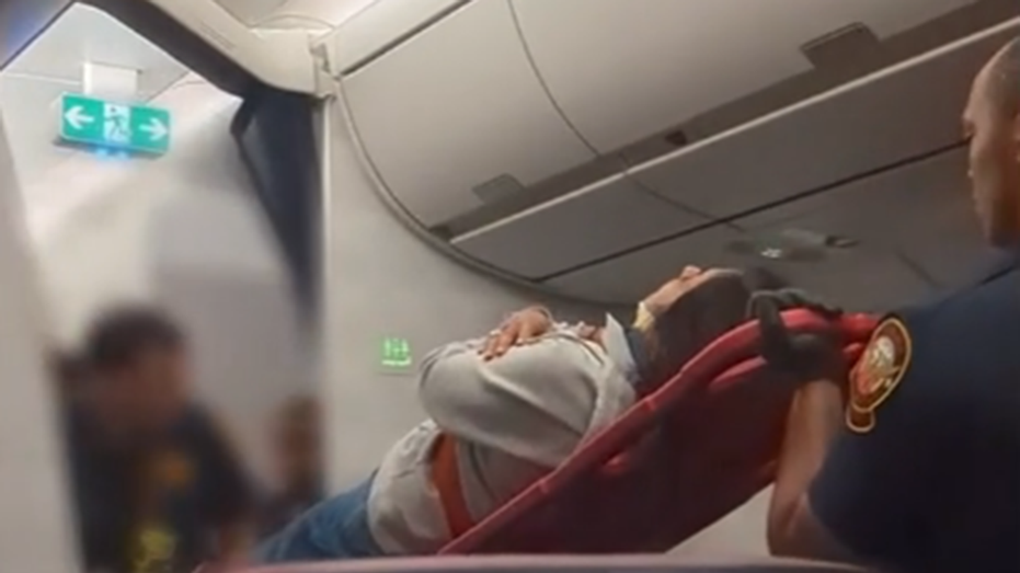 Injured traveler removed from plane on stretcher 