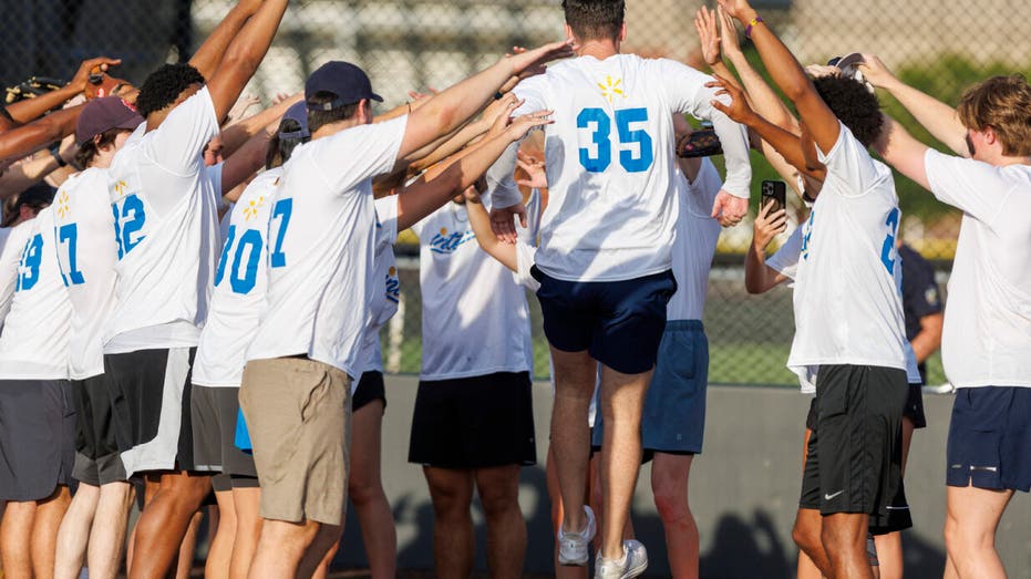 A scene from the Walmart Interns v. Executives softball game