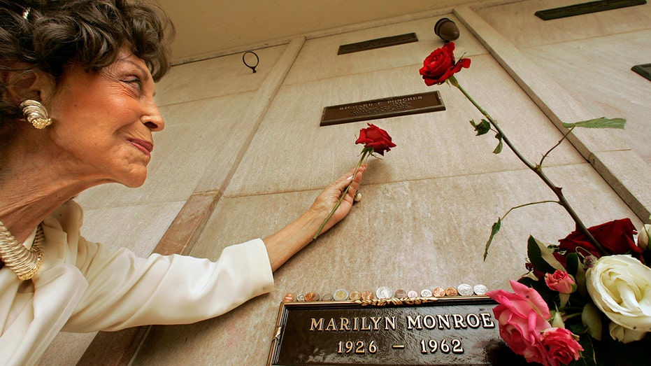 Elise Poncher looking up towards her husband's crypt