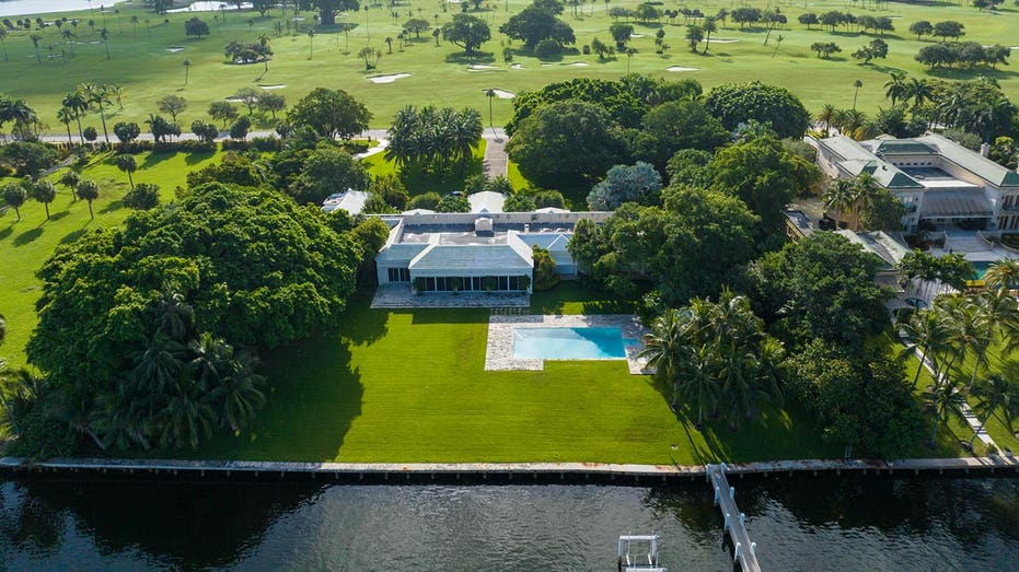 An overheard view of the home with a golf course in the background