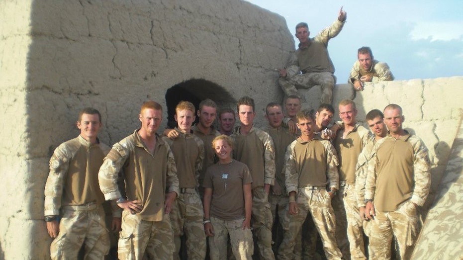 A group of members from the military posing together outdoors