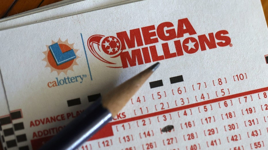 A pencil and Mega Millions lottery tickets