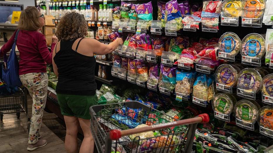 Customers shop in grocery aisle