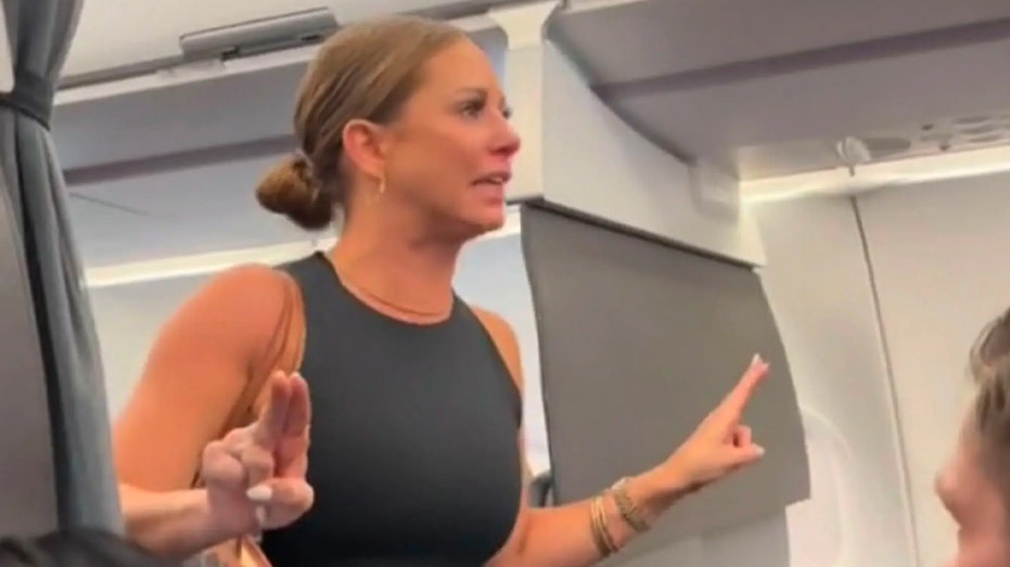 Tiffany Gomas gestures on an American Airlines plane during a meltdown caught on video