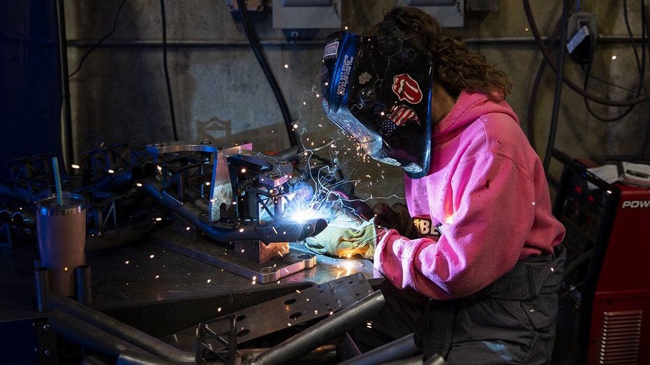 Young woman does welding job