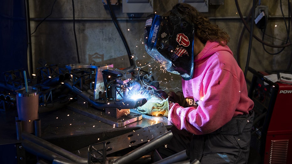 Young woman does welding job 