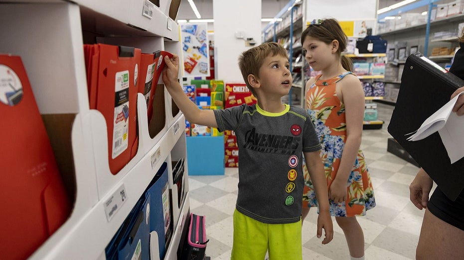 kids and parent shopping for school supplies