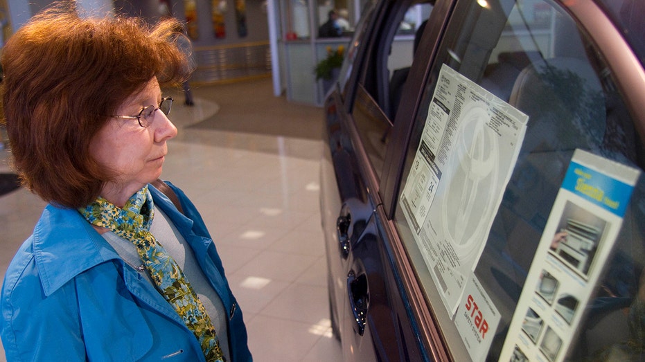 A customer looking at a car for sale in a dealership