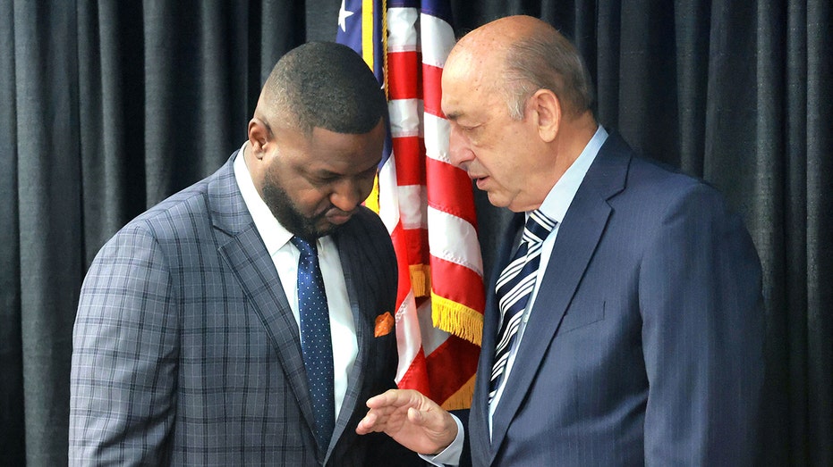 Central Florida Tourism Oversight District Board administrator Glen Gilzean speaks with board member Ron Peri