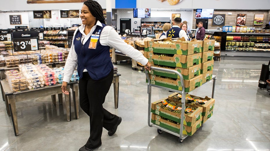 grocery manager pulling cart of fruit