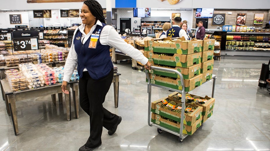grocery manager pulling cart of fruit