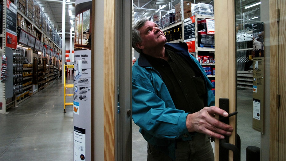 A customer examines sliding glass doors in Home Depot