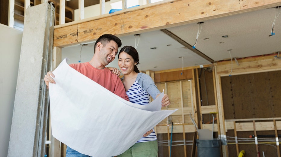 home buyers check blueprints