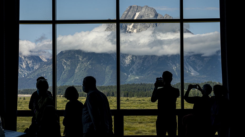 Visitors take photos of the Grand Teton National Park
