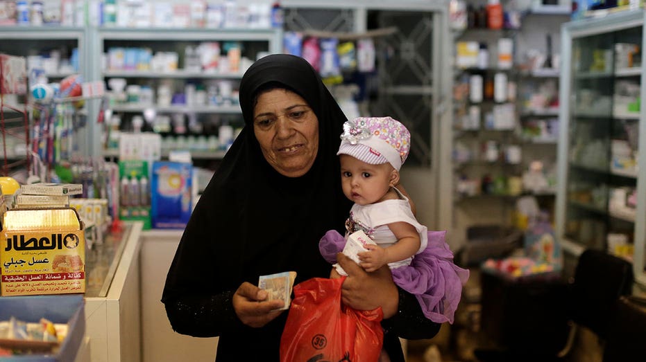 Syrian woman leaves a pharmacy 