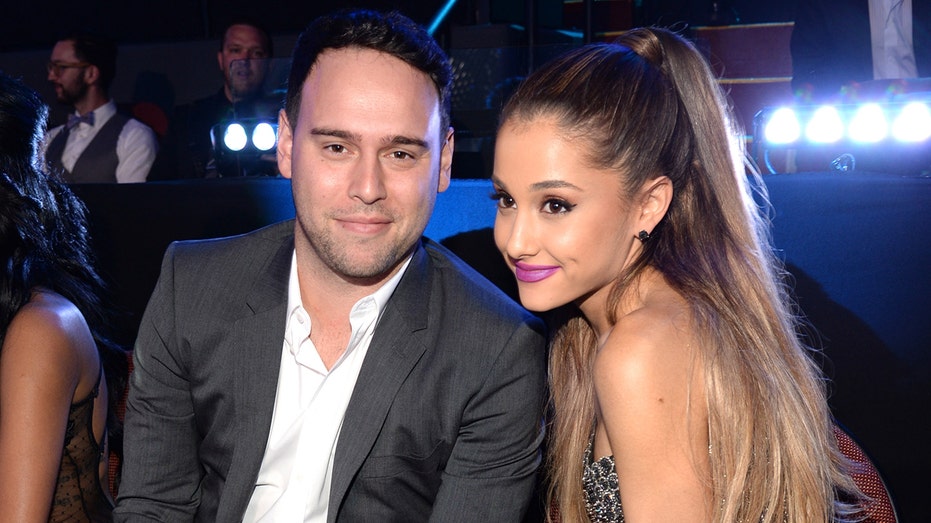 Ariana Grande smiles next to Scooter Braun at MTV Awards